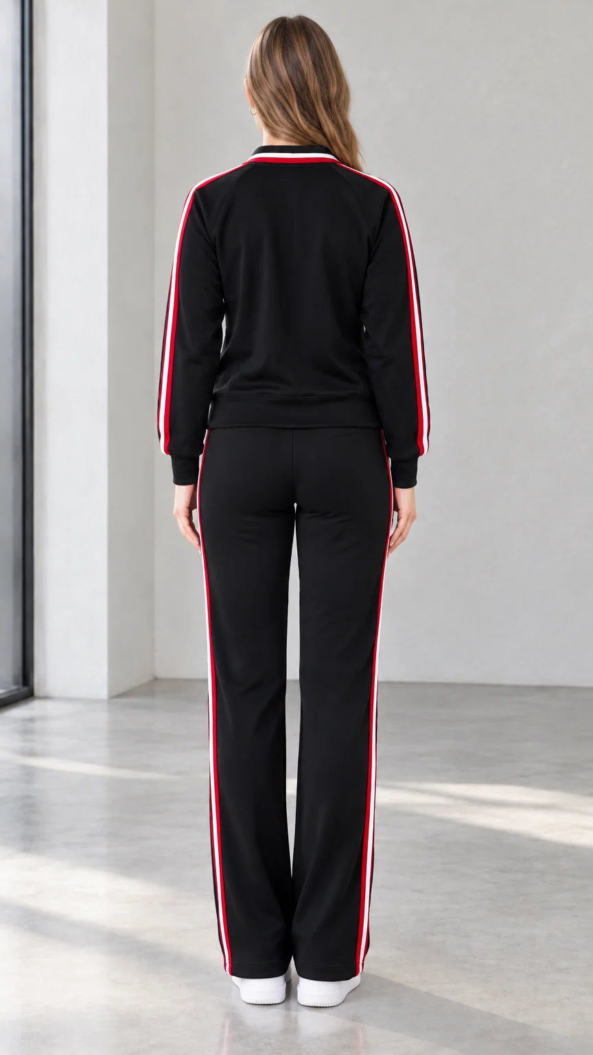 Back view of black sporty track jacket and matching straight pants