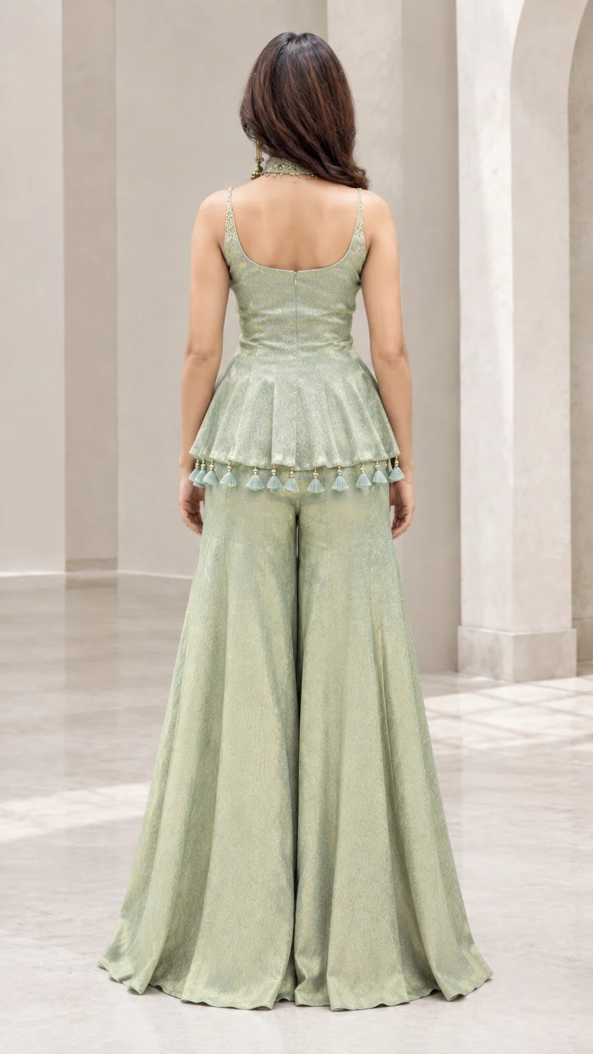 Back full view of woman wearing sage green peplum sharara set