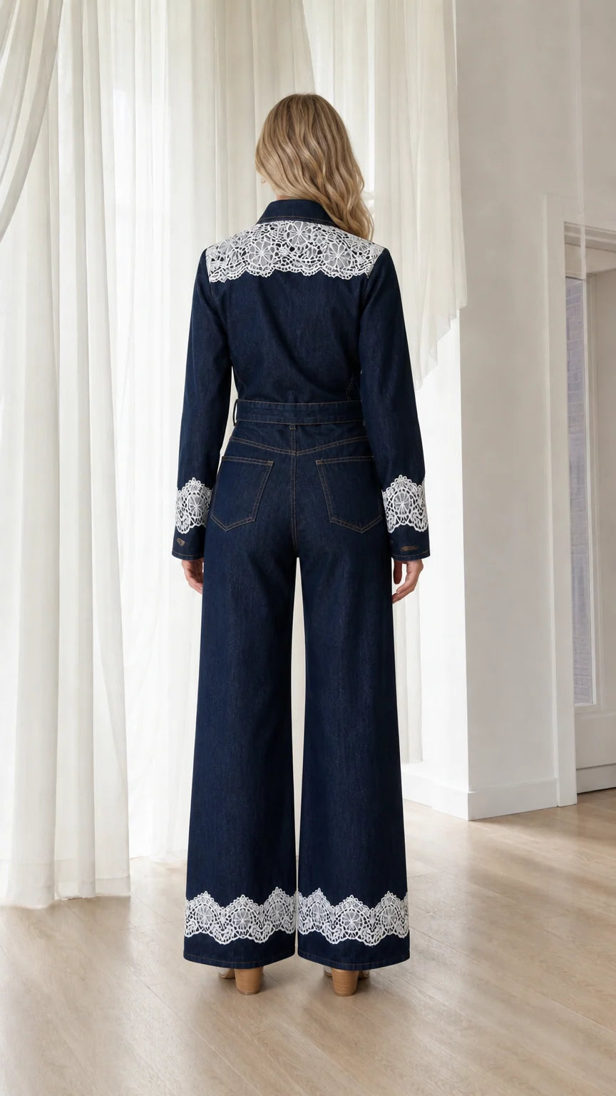 Back view showcasing white lace hem on dark denim jumpsuit