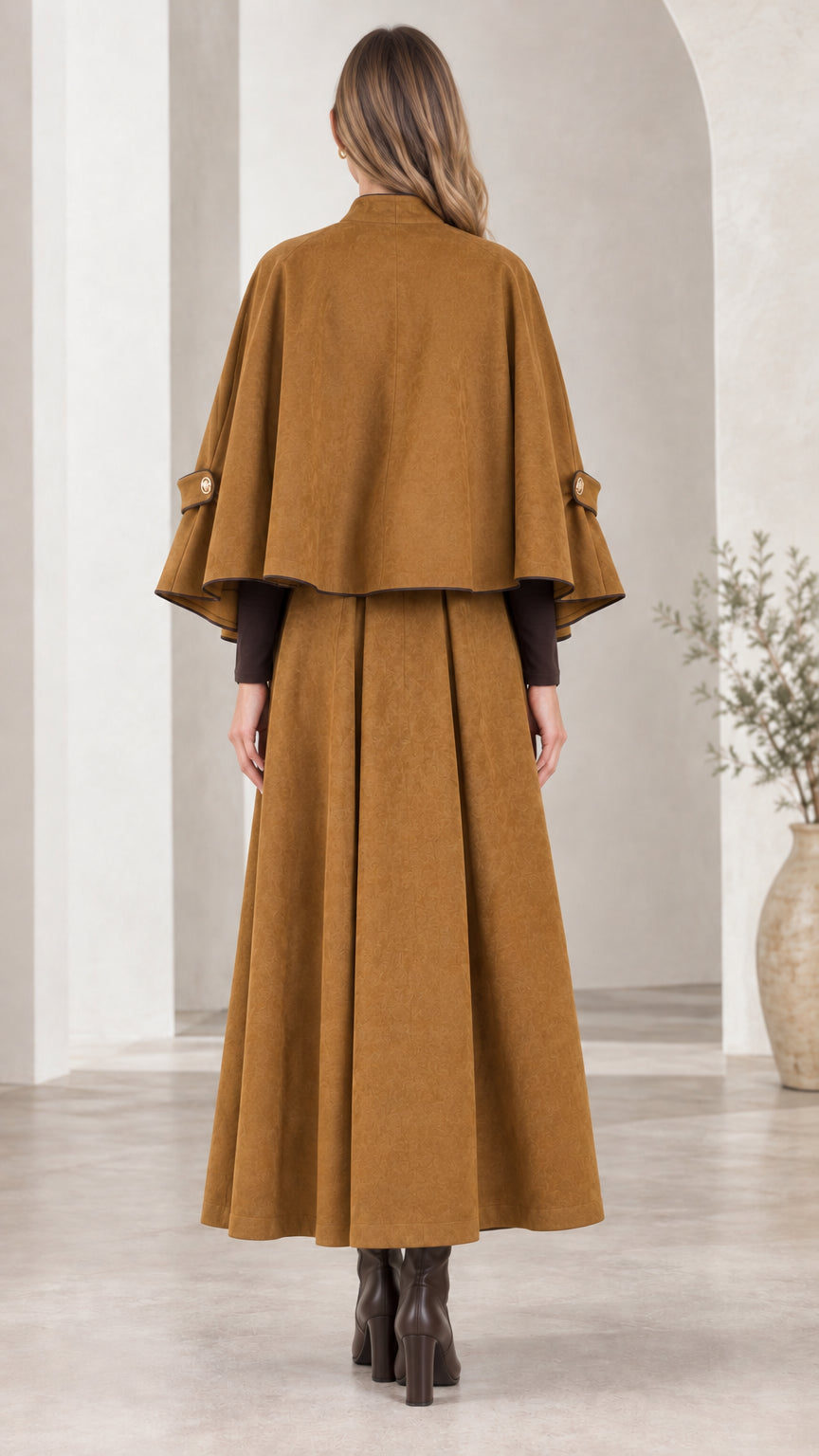 Back view of Camel cape and pleated maxi skirt ensemble