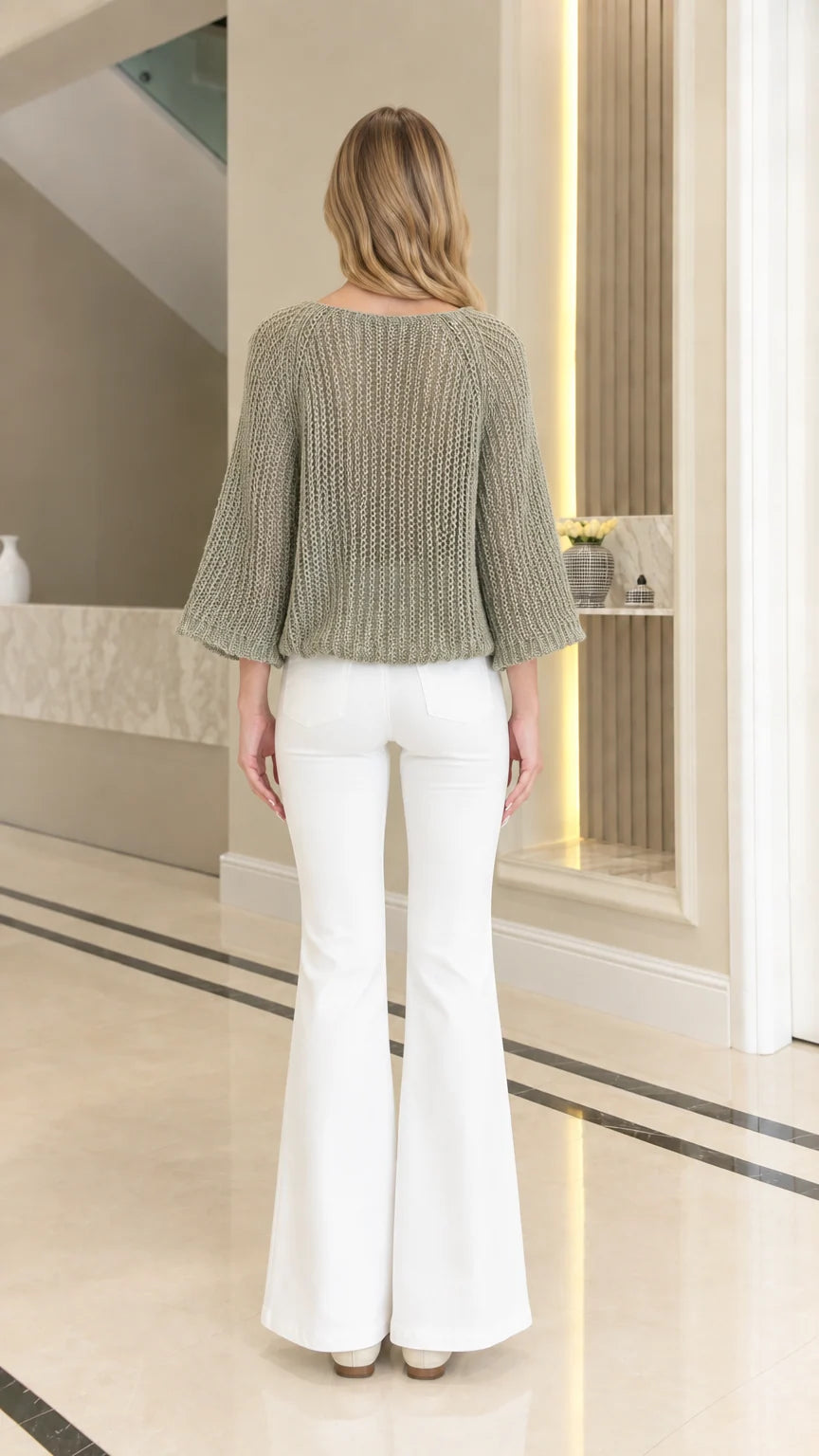 Back view of woman wearing relaxed fit sage green open-knit boatneck sweater