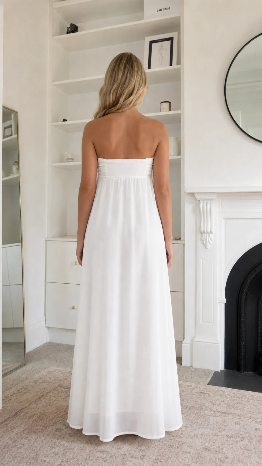 Back view of woman wearing white strapless maxi dress