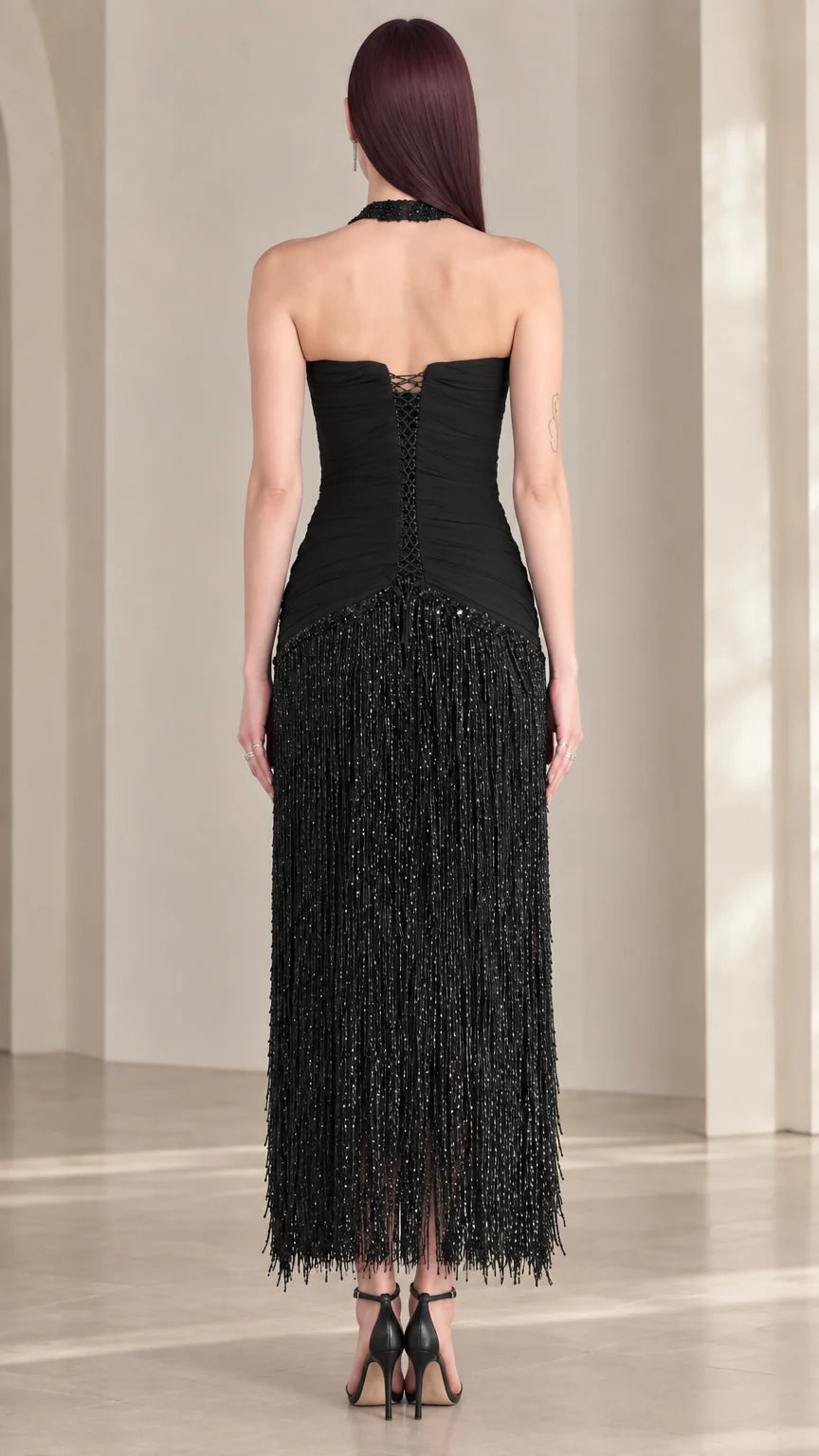 Back view of black halter open back fringe evening dress