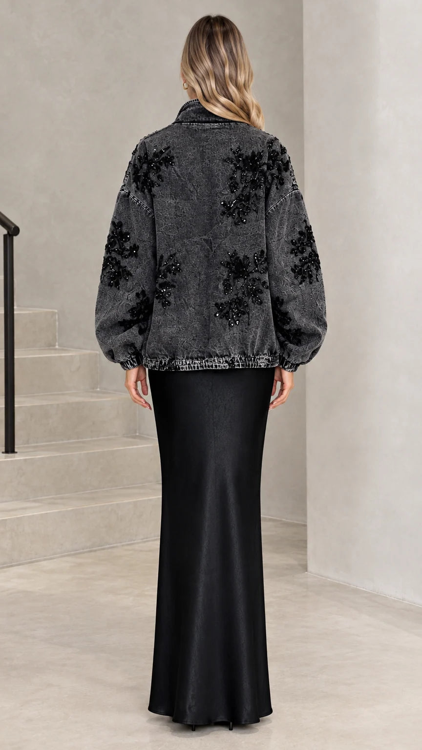 Back view of washed black denim jacket highlighting floral sequin details across the back