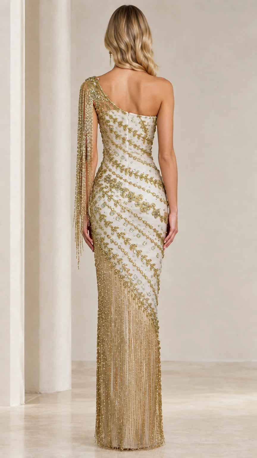 Back full-length view of Ivory Gold one-shoulder gown with diagonal beading and fringe hem