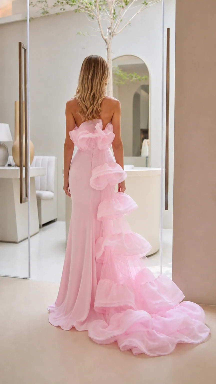Back view of the evening gown highlighting cascading ruffle train