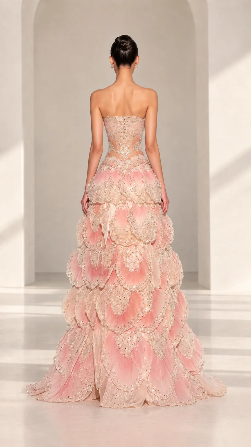 Back view of Blush Pink strapless evening gown showing corset back and subtle train