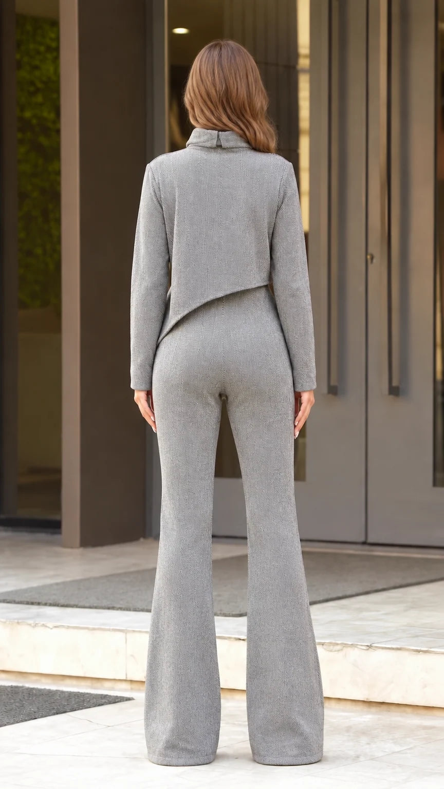 Back view of woman wearing grey mock neck top and high waist flared pants