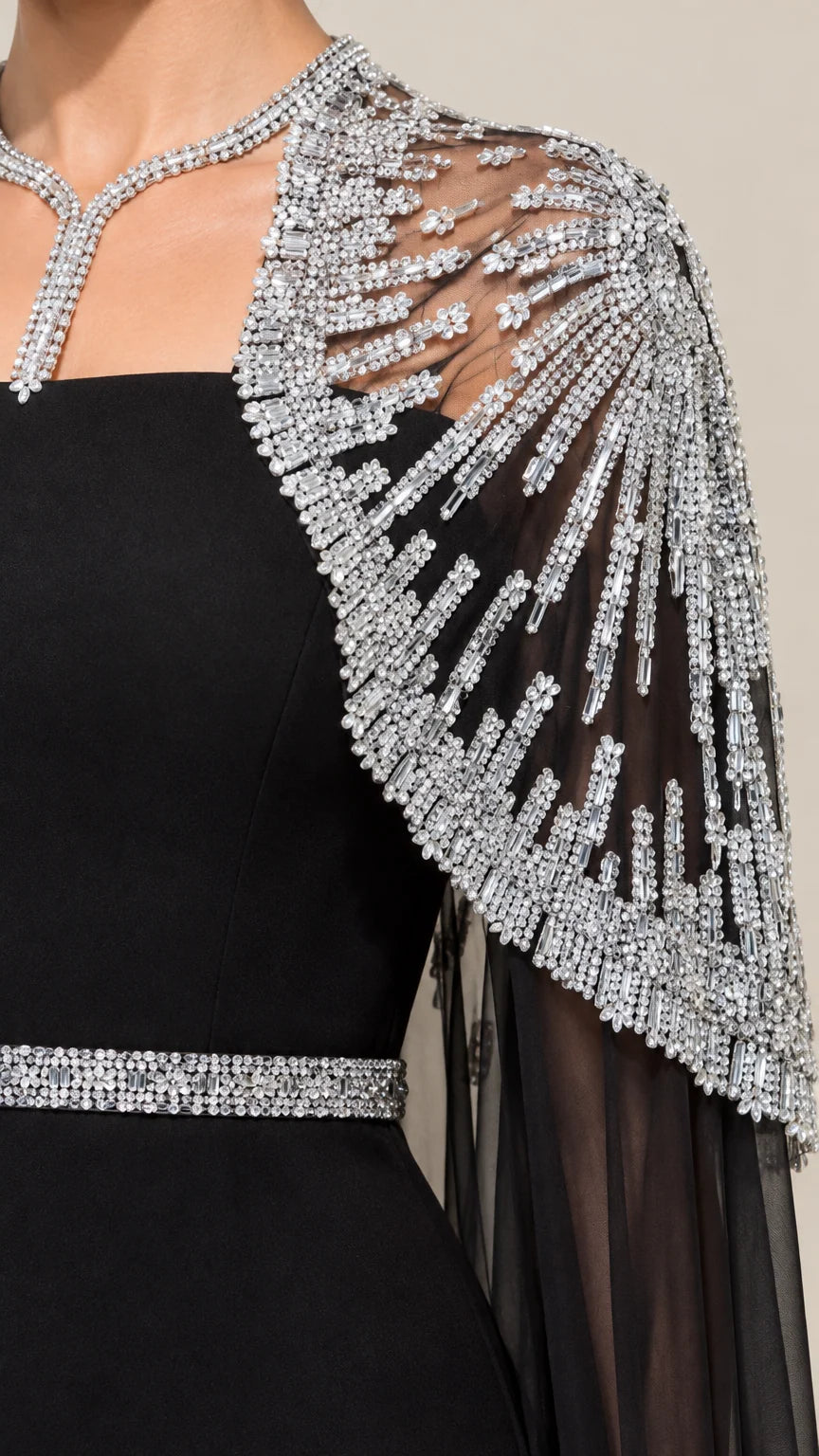 Close-up detail of intricate silver sequin and beaded sunburst capelet and waistband