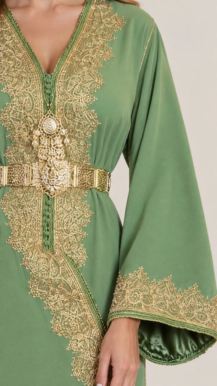 Close-up of intricate gold lace embroidery and ornate belt on sage green kaftan dress
