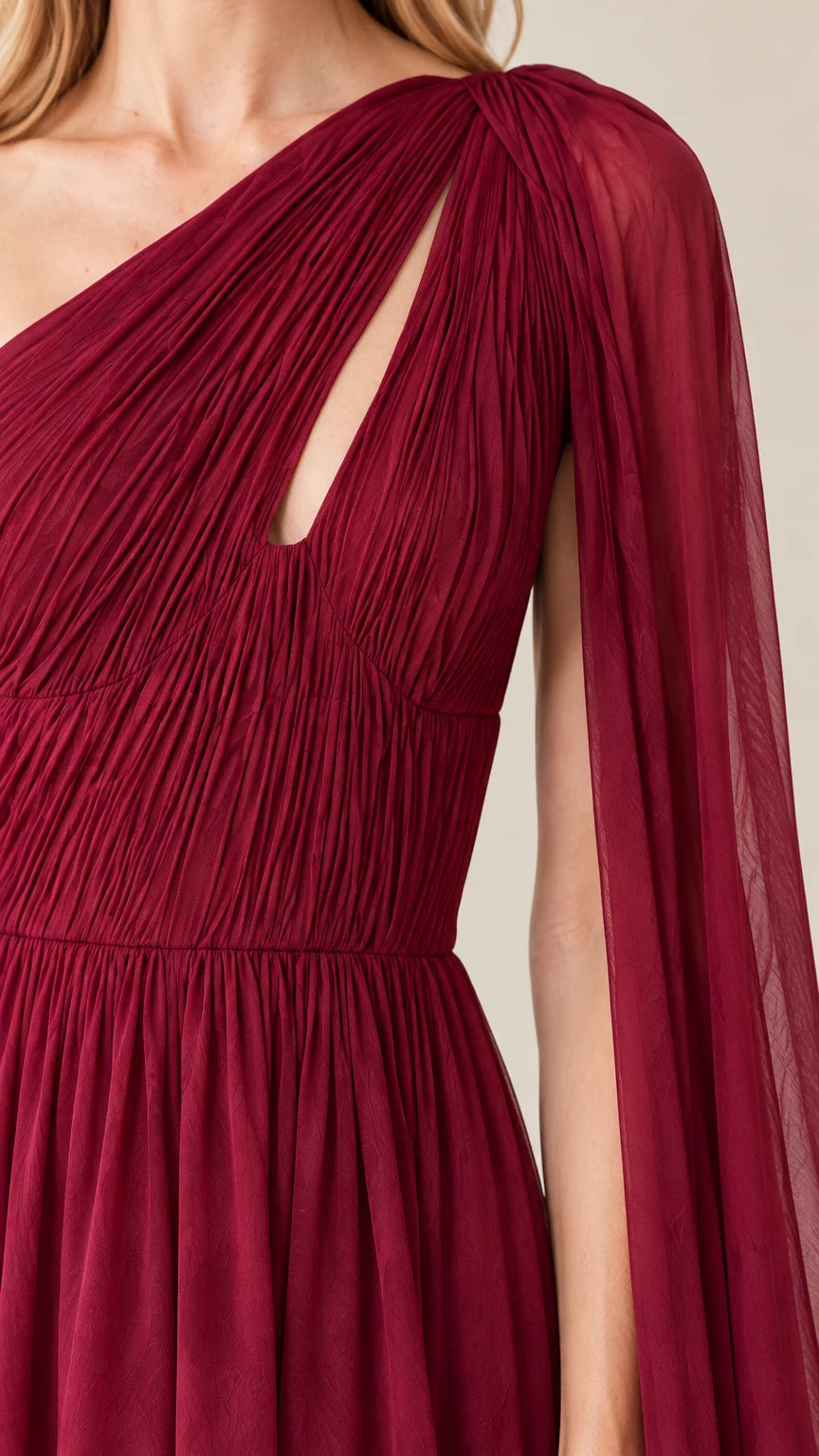 Close-up detail of pleated burgundy bodice with asymmetrical neckline cutout