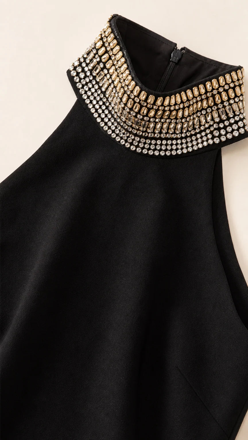 Close-up of sparkling crystal and rhinestone embellishments on black halter collar