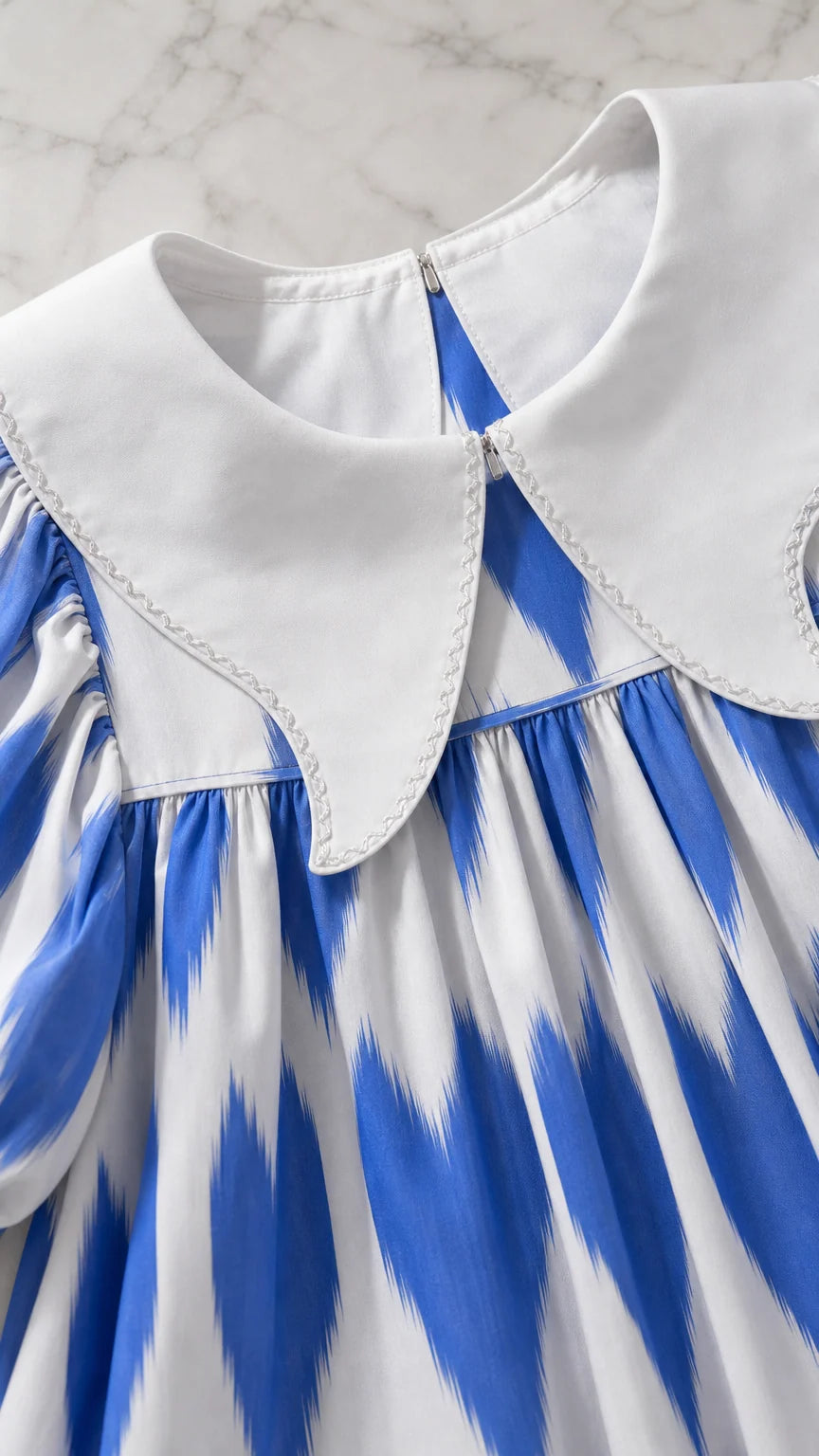 Close-up of white pointed contrast collar and neckline on printed tunic