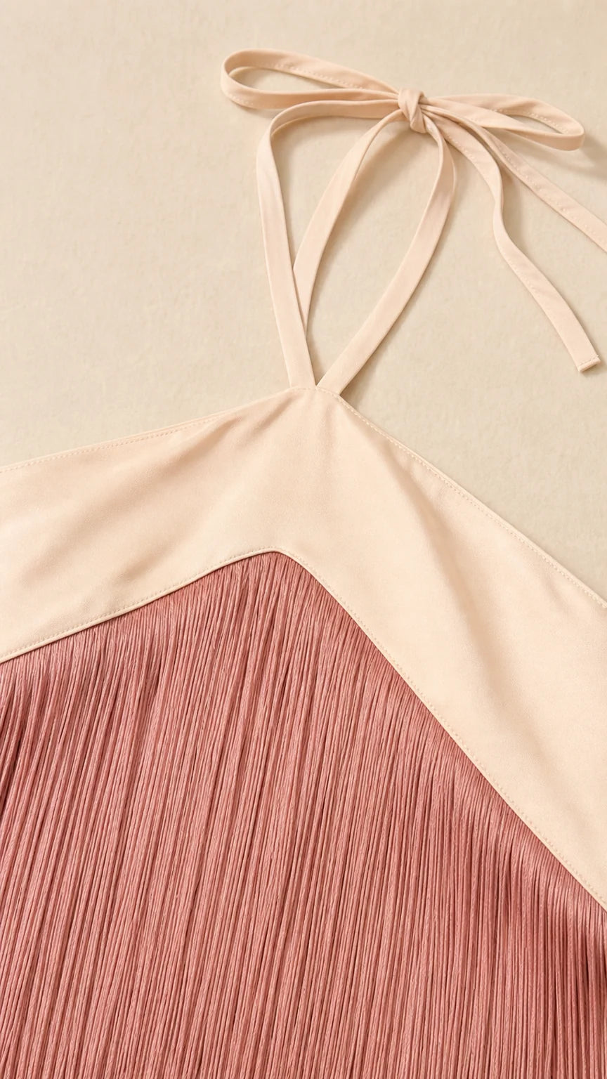 Close-up detail of halter neckline strap and delicate fringe trim texture