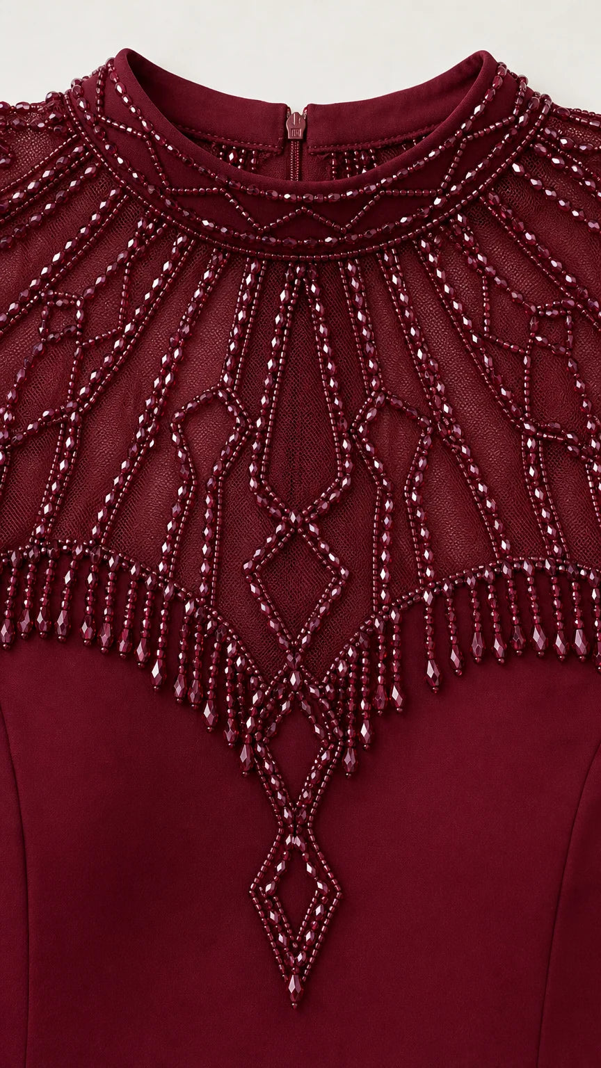 Close-up detail of ornate beadwork and fringe on neckline and cap sleeves