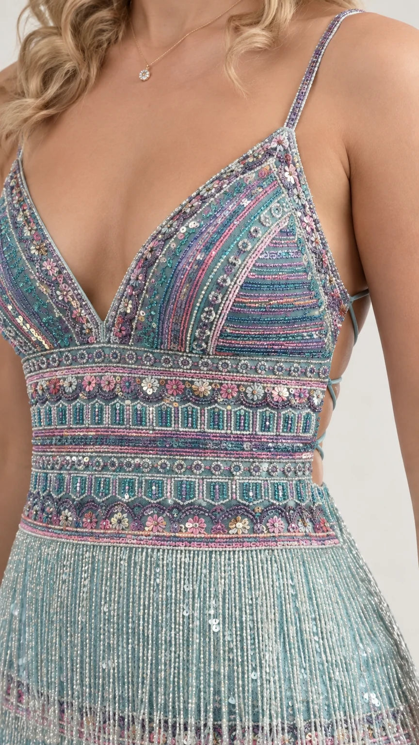 Close-up detail of geometric beadwork and dangling fringe hem