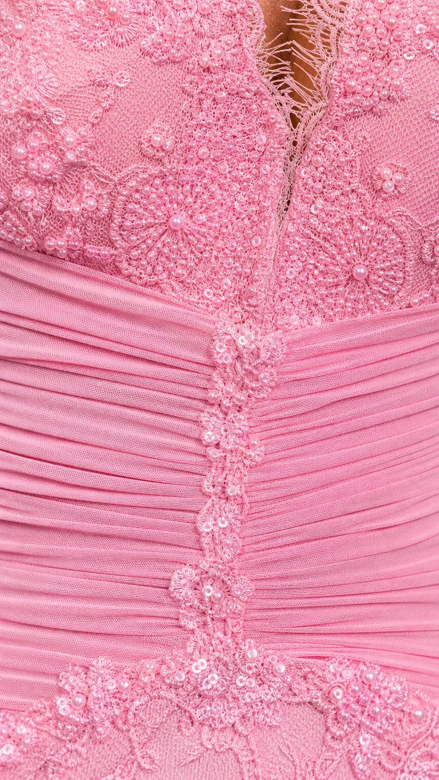 Close-up detail of lace texture and ruched bodice on pink dress