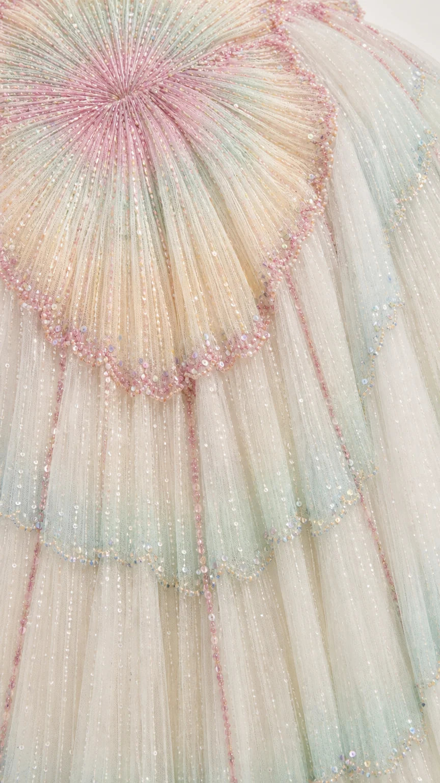 Close-up detail of intricate beadwork and tulle pleating