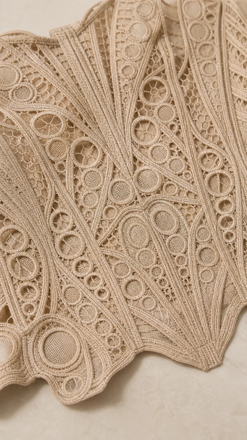 Close up fabric texture view of geometric crochet lace pattern in beige