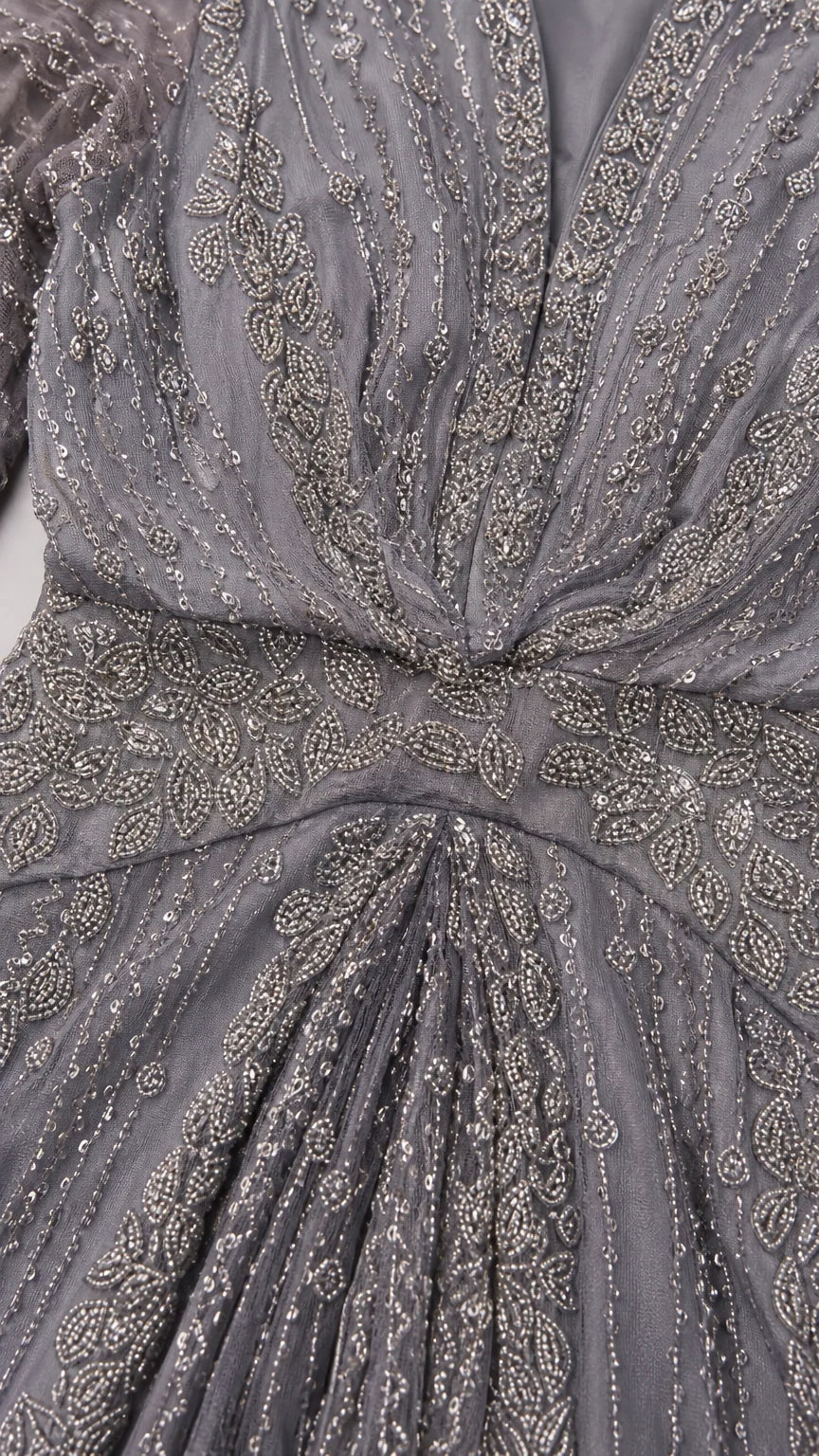 Close-up detail of intricate beading and sequin embroidery on slate grey bodice