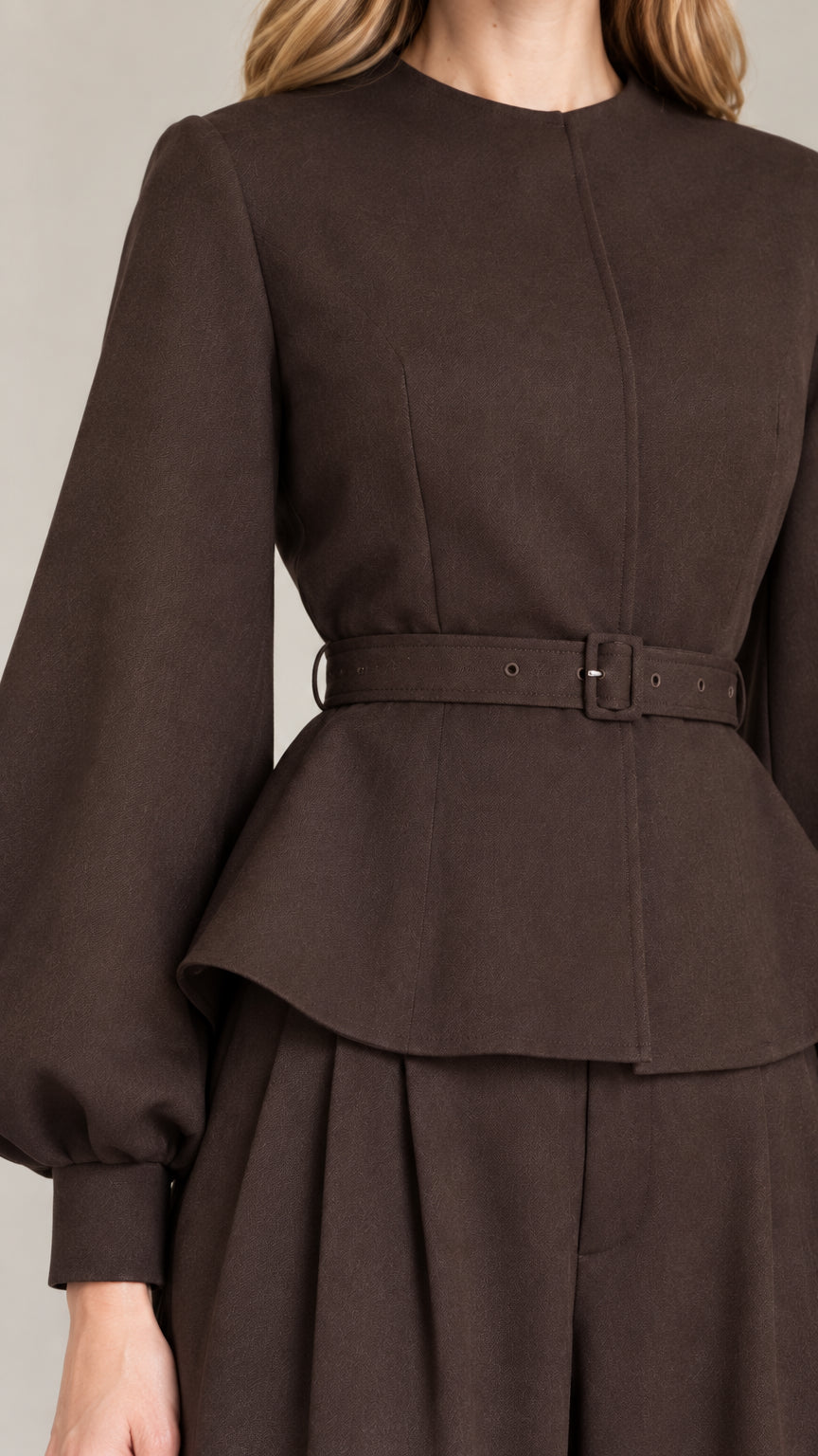 Close-up detail of Dark Brown peplum top showing fabric texture, neckline, and matching belt buckle