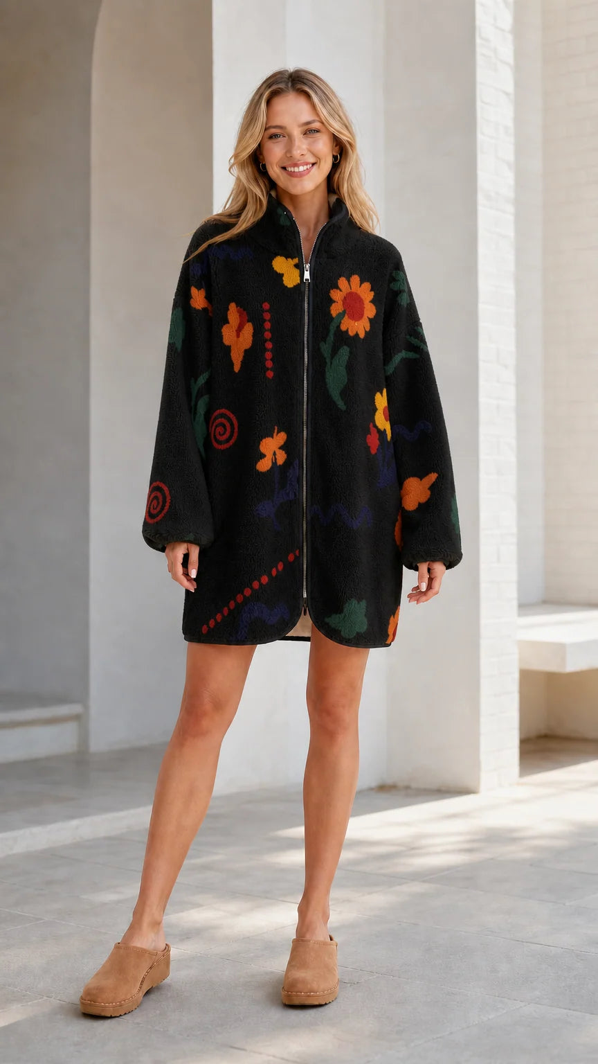 Front view of a black women's floral printed fleece zip-up jacket