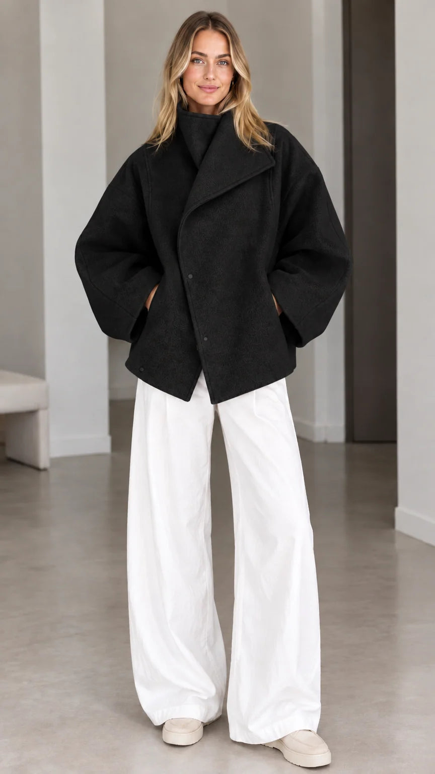 Model wearing classic black asymmetrical high neck short jacket