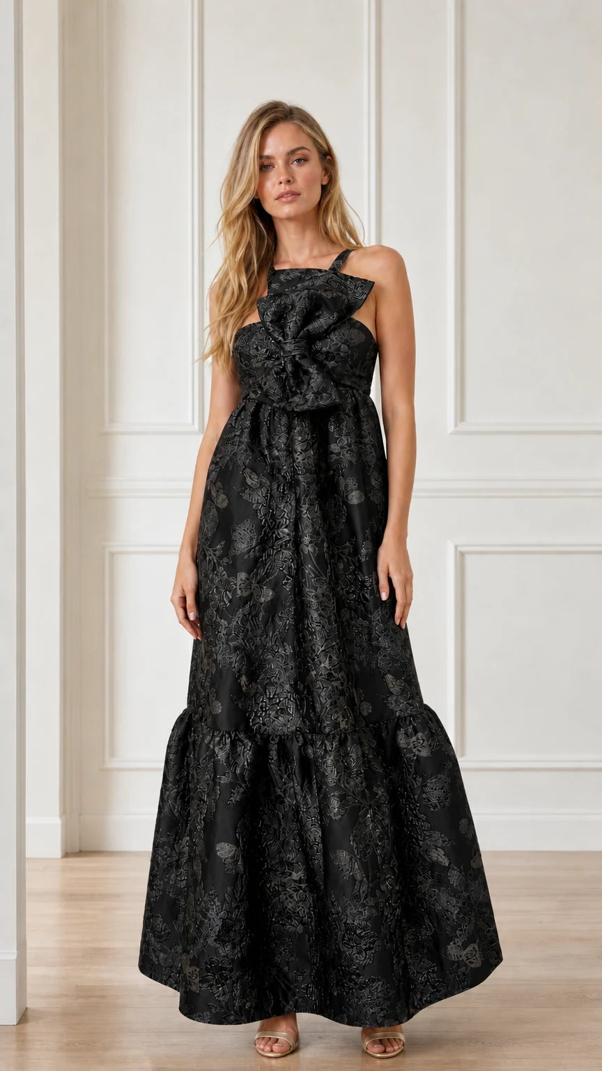 Front view of black brocade maxi dress with bow