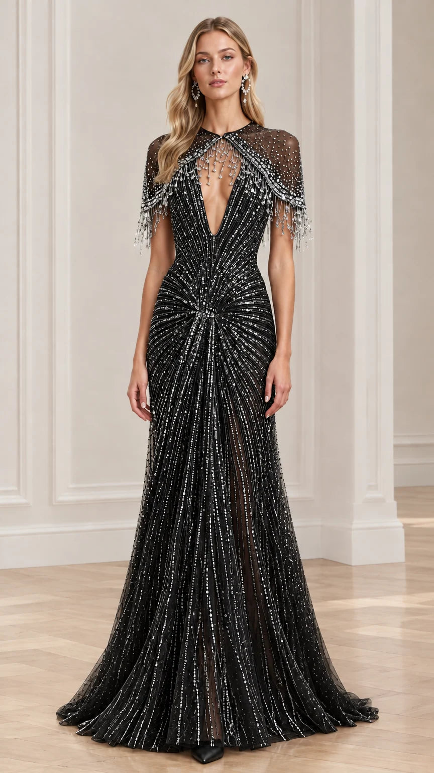 Front view of black beaded capelet evening gown with shimmering details