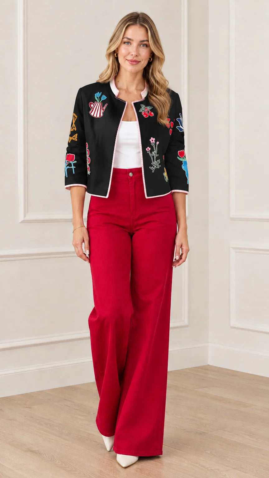 Black embroidered open front cropped jacket styled with red trousers
