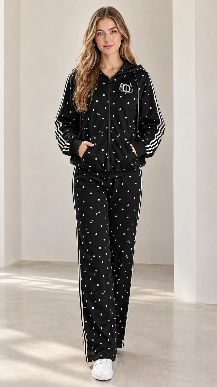 Model wearing black polka dot two-piece tracksuit set with white athletic side stripes