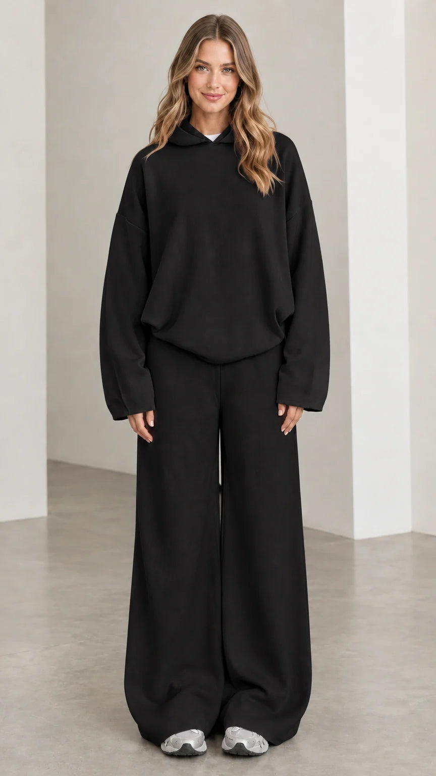 Front view of woman wearing Black oversized hoodie and wide leg pants lounge set