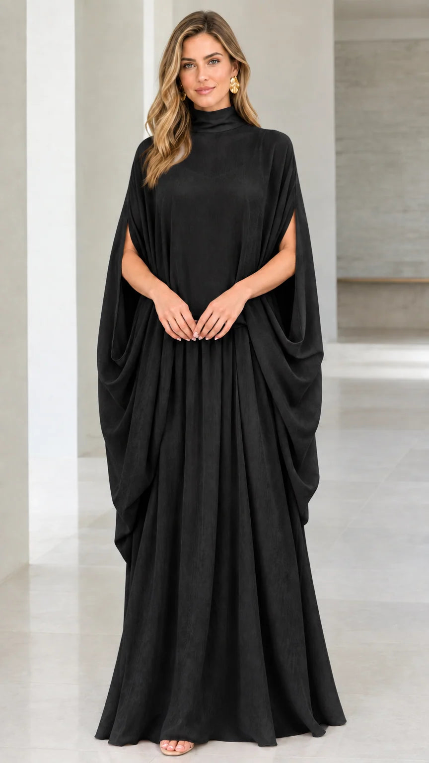 Front view of model wearing black high neck cape sleeve maxi dress