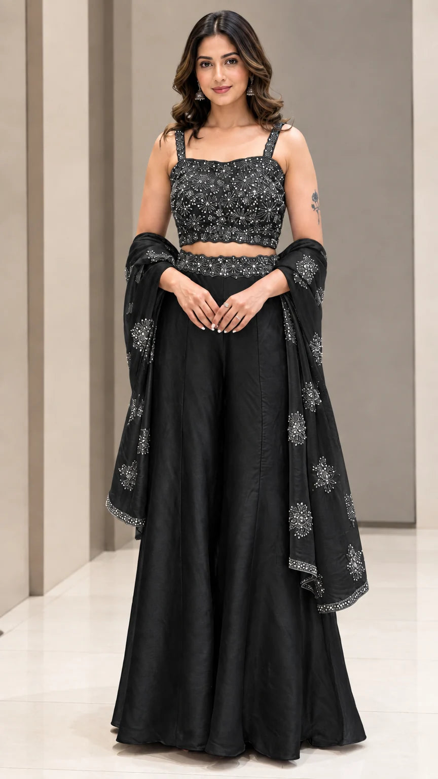Full-length studio view of woman wearing Black embroidered crop top and wide-leg palazzo pant set