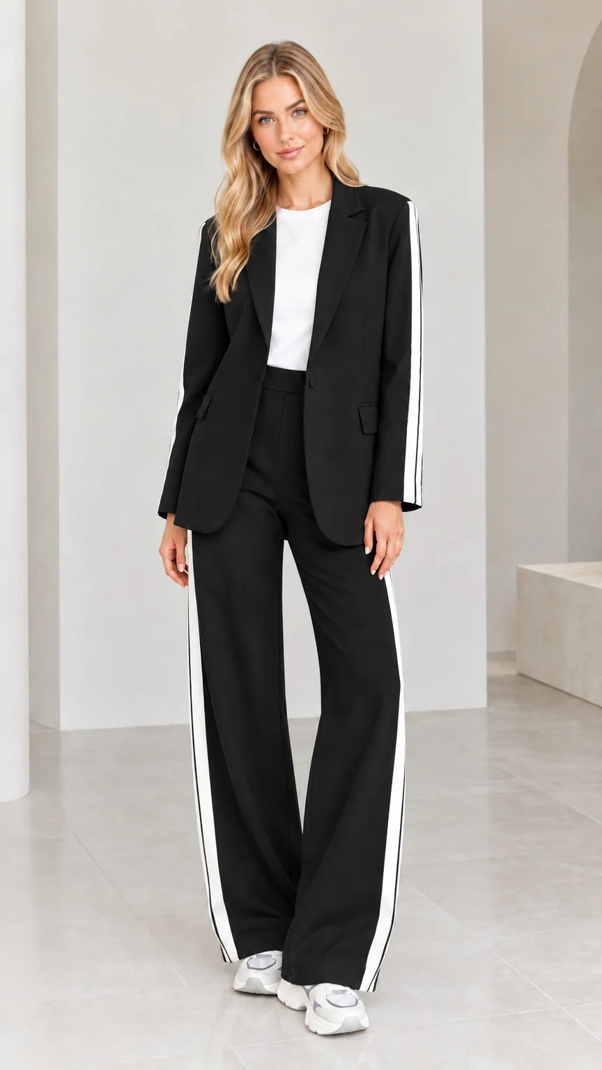 Model wearing black 2-piece blazer and wide-leg pants suit set with white side stripes