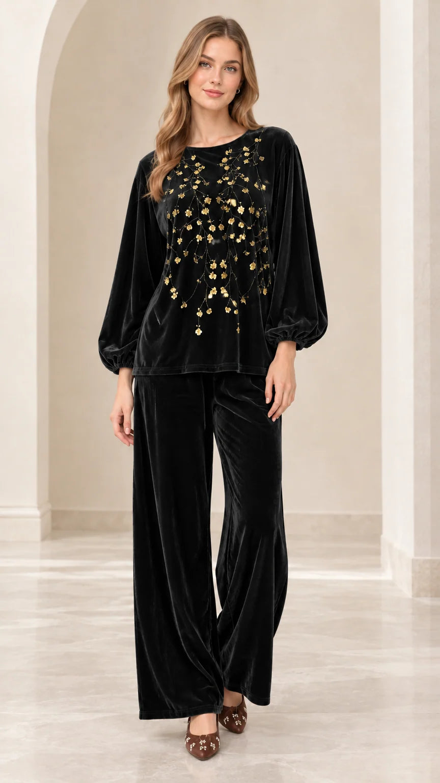 Front view of women's black velvet two-piece set with gold floral sequins