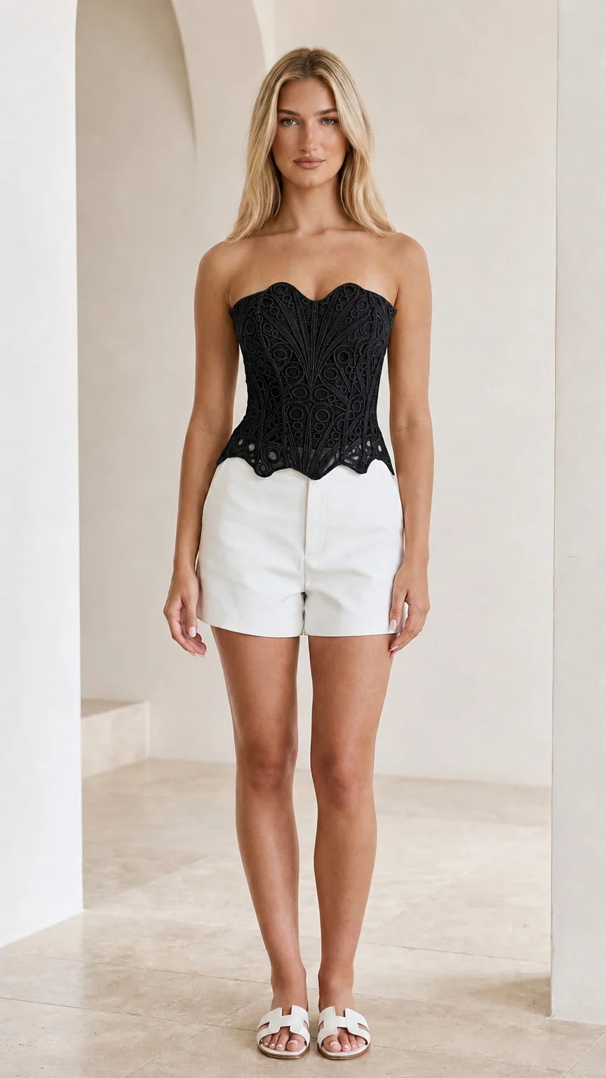 Front view of woman wearing black strapless crochet lace corset top