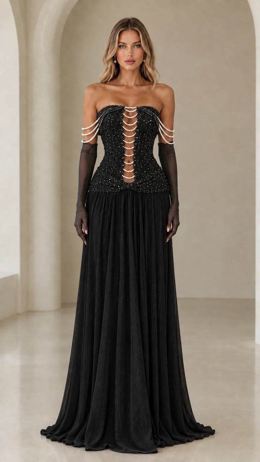 Model wearing black strapless pearl corset evening gown with black sheer gloves