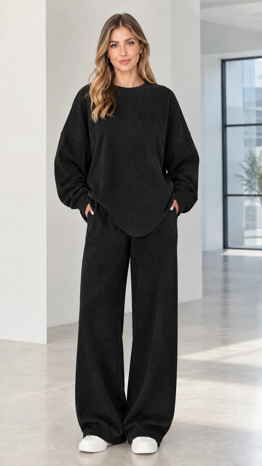 Woman wearing black two-piece ribbed crewneck top and wide-leg lounge pants set