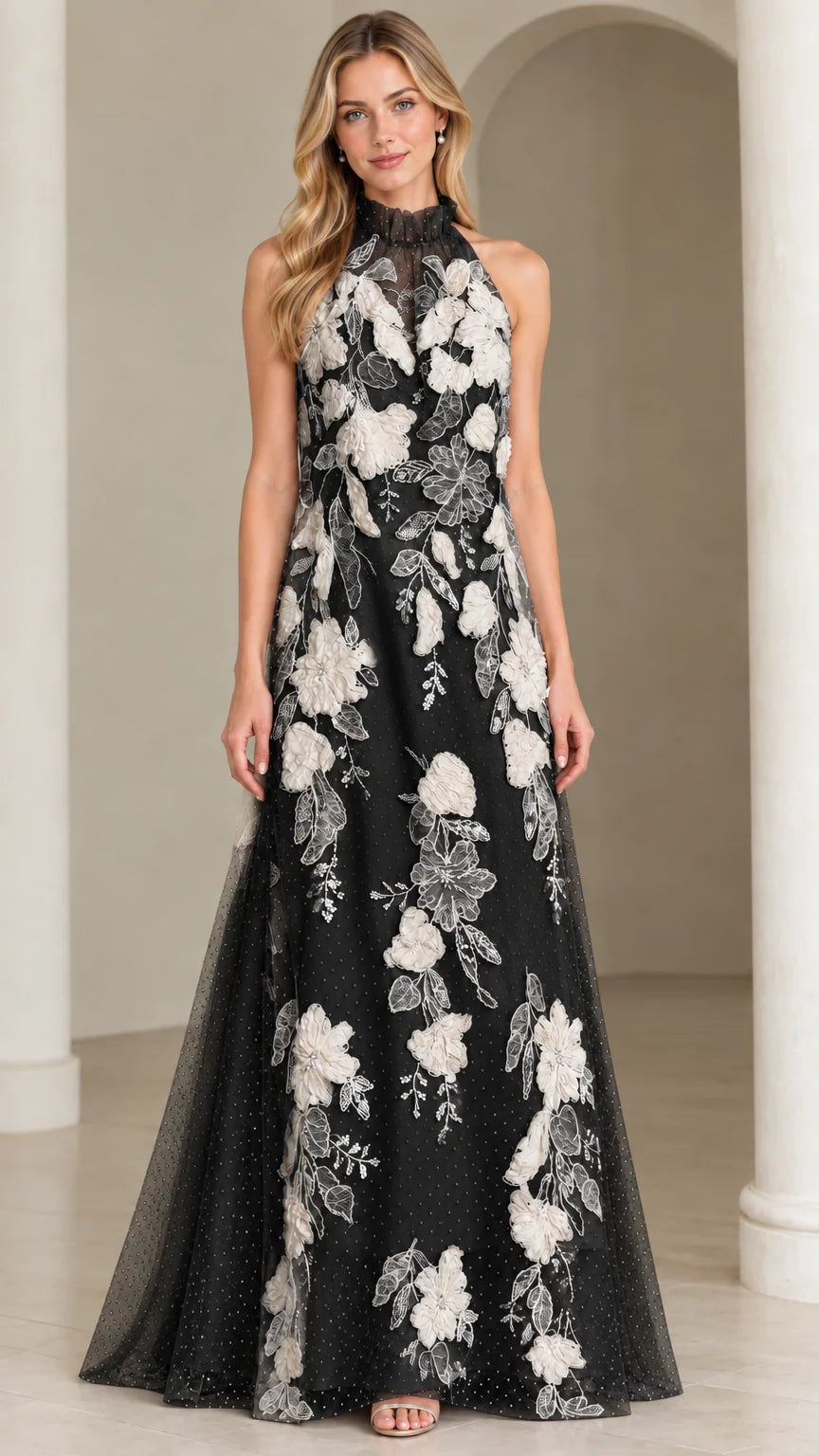 Front view of black halter maxi dress with contrasting white floral appliques