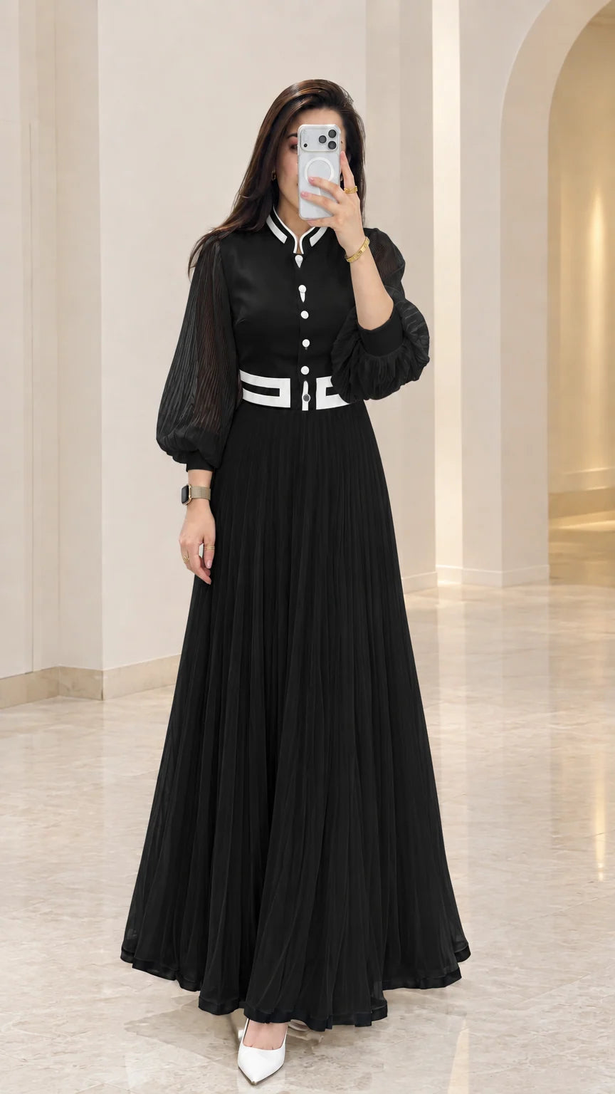 Black pleated maxi dress with contrast white button and trim accents