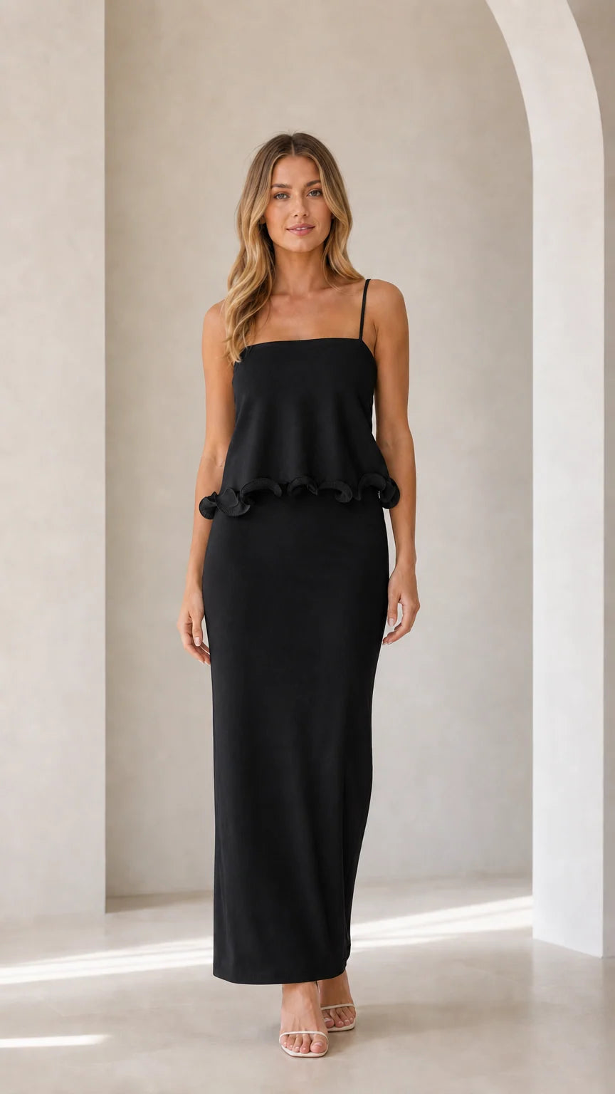 Model wearing black sleeveless ruffle trim maxi camisole dress