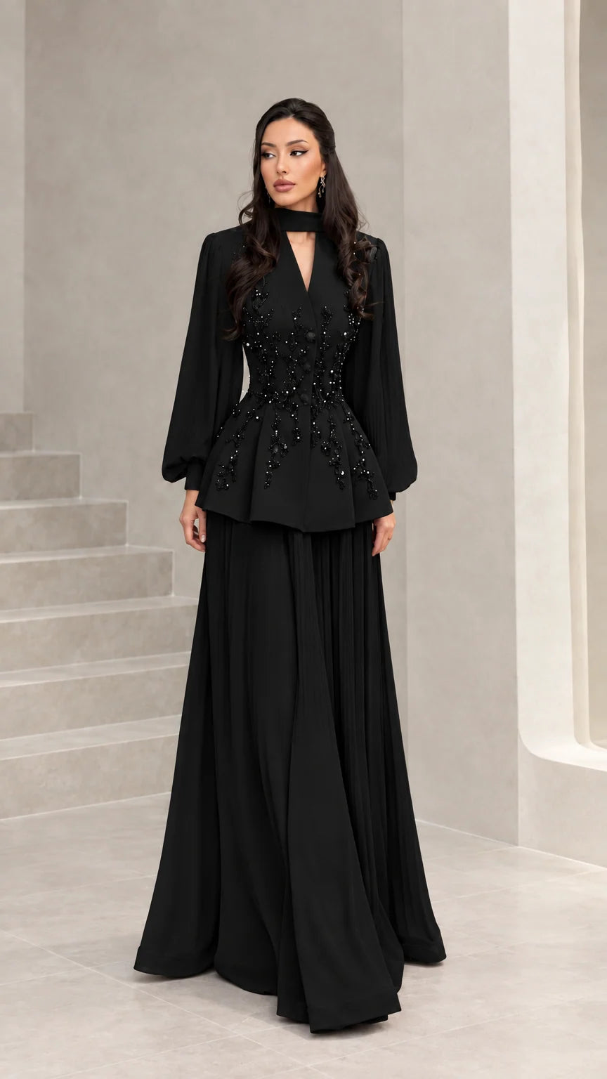 Front view of black long-sleeve beaded peplum formal evening gown