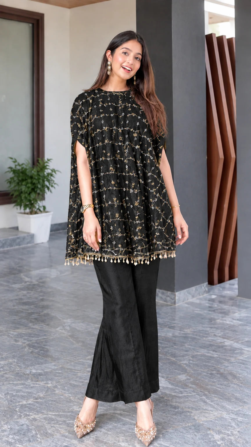 Model wearing black embroidered cape tunic and matching flared trousers