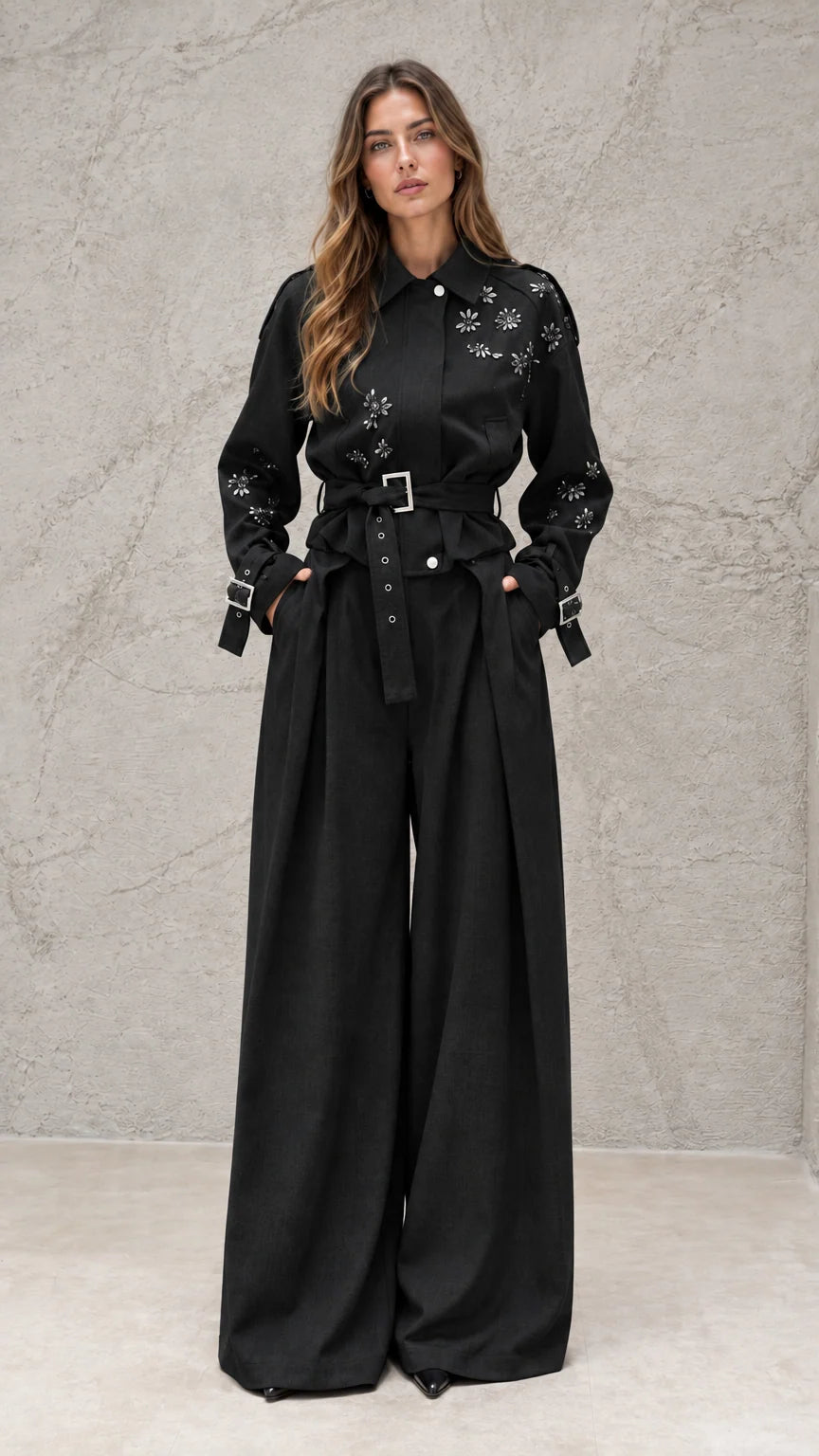 Full front view of model wearing black embellished wide-leg jumpsuit