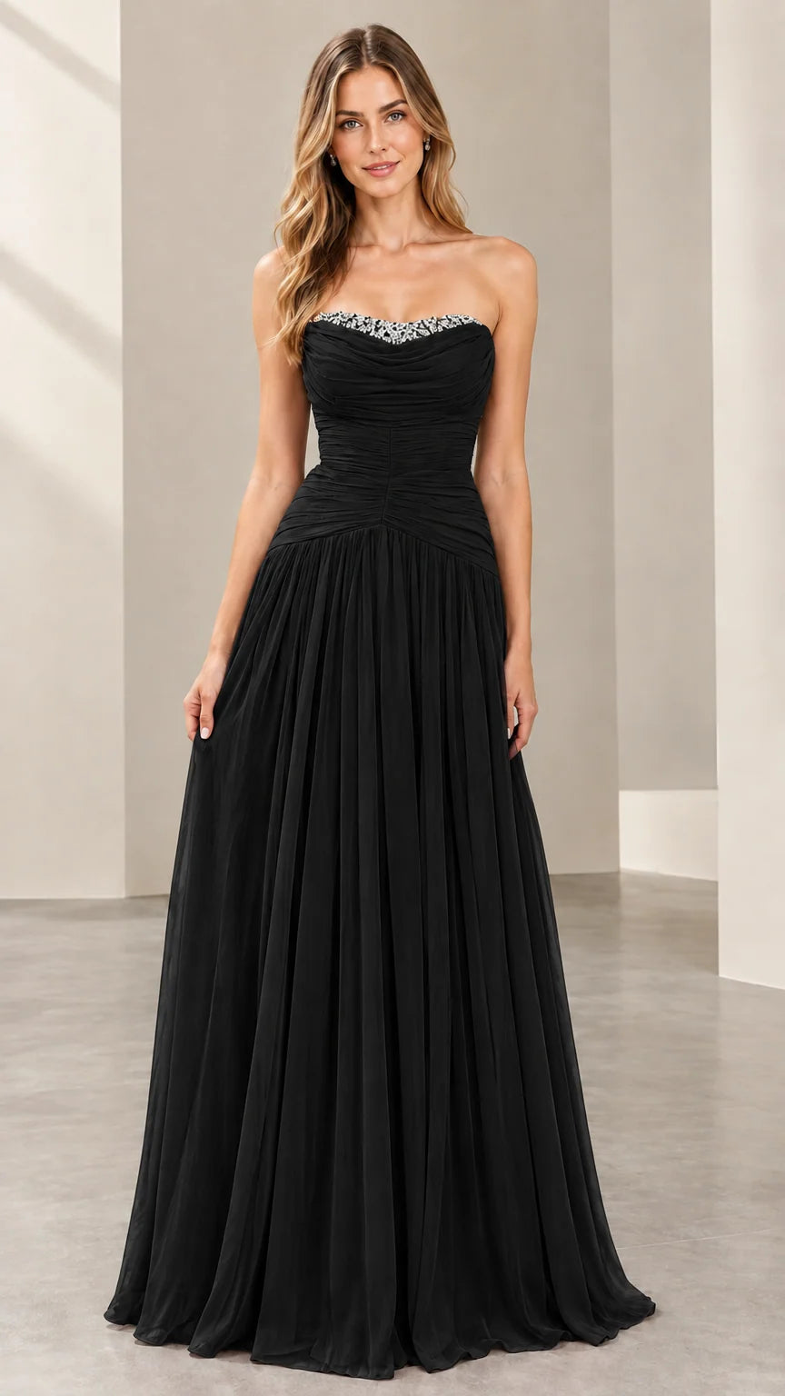 Front view of woman wearing the strapless ruched evening gown in black