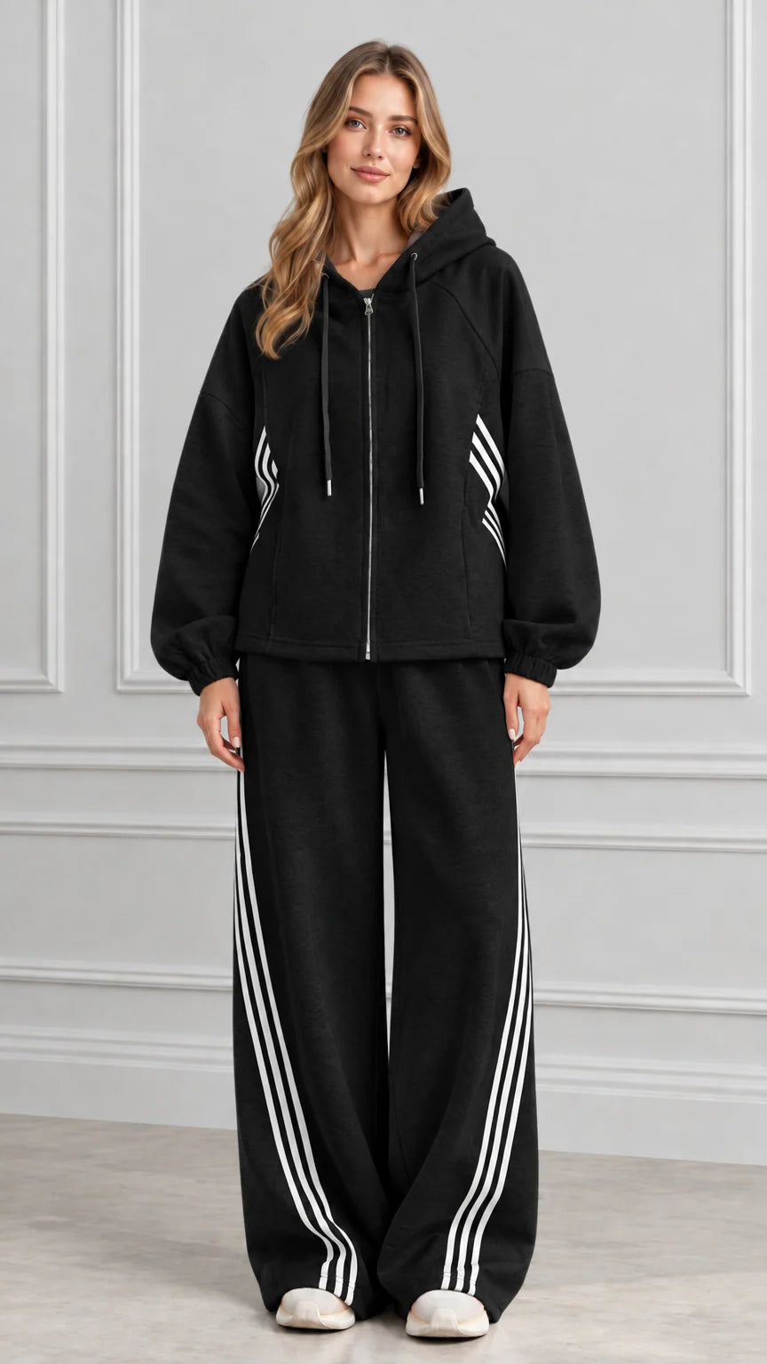 Front view of woman wearing Black zip-up hoodie and wide-leg pants set with white stripes
