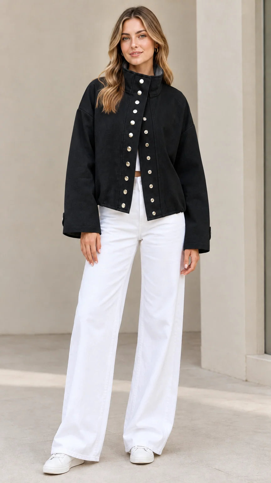 Full-length view of woman wearing Black stand collar snap-front jacket with white pants