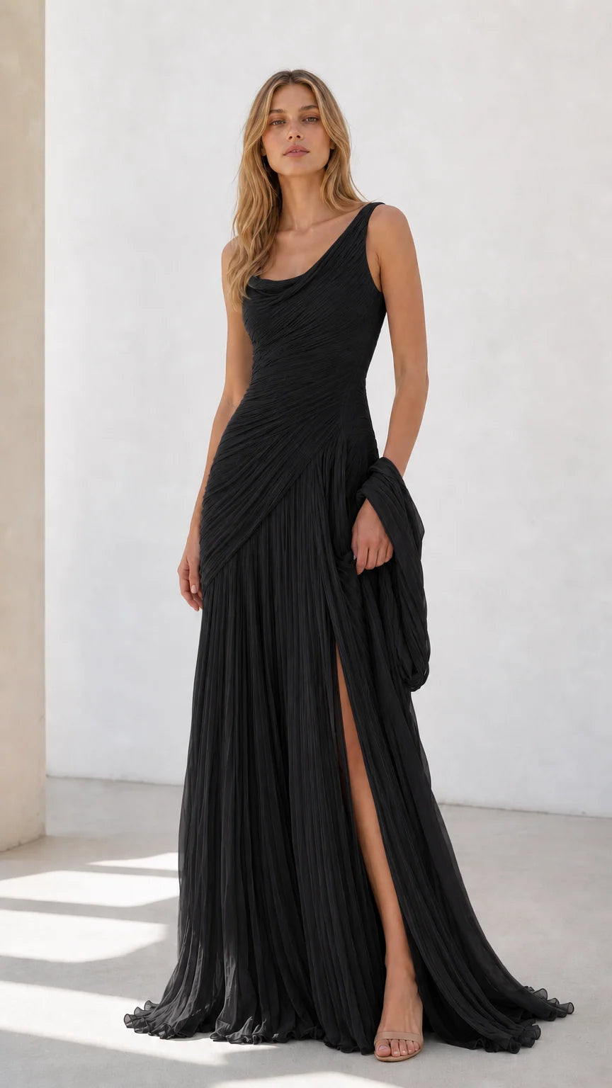 Full view of black pleated draped evening dress with side slit