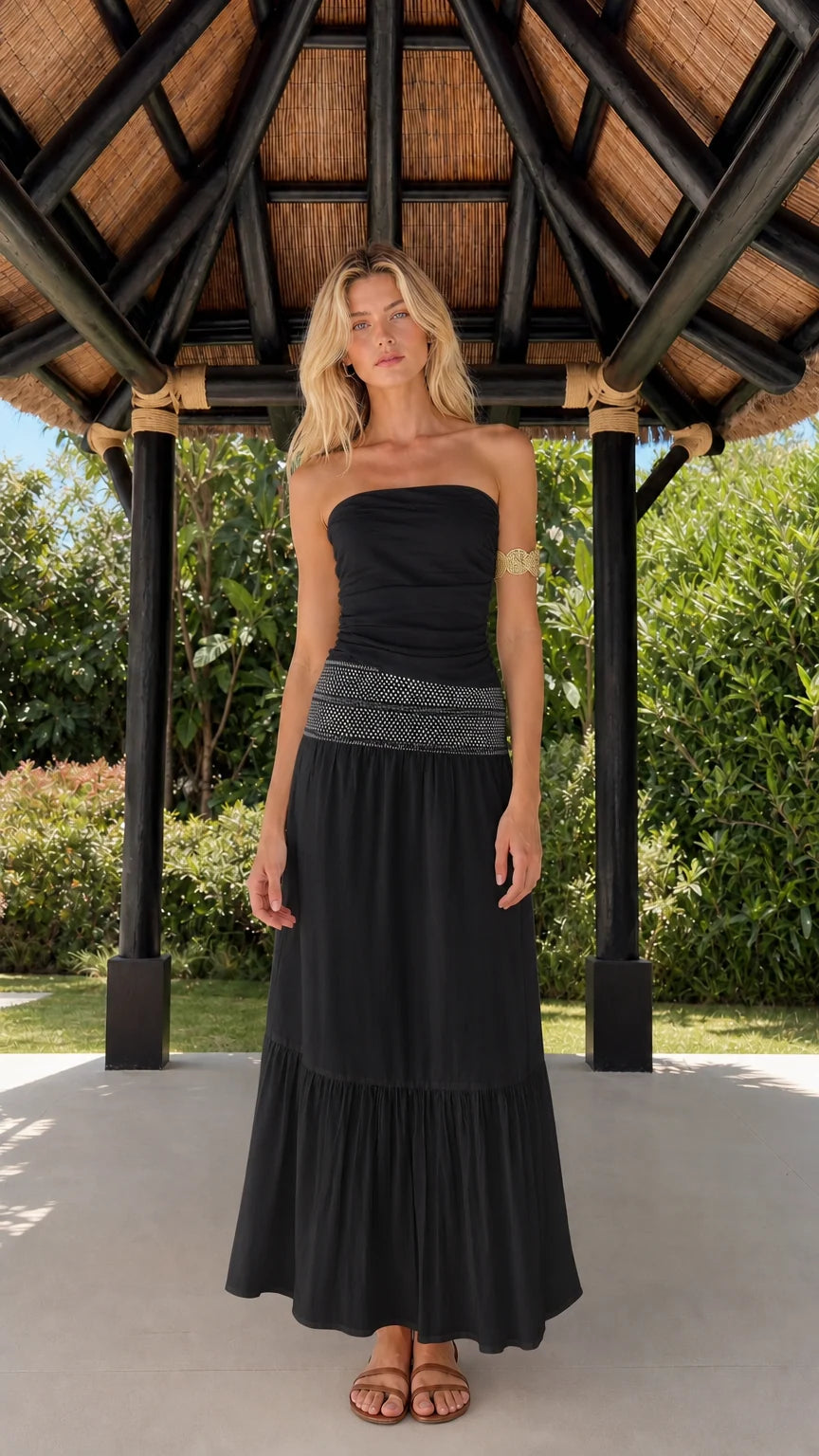 Woman wearing black strapless tiered maxi dress